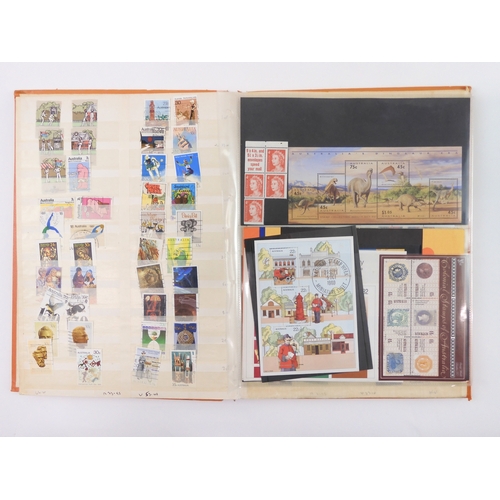 7021 - AUSTRALIA <br />A collection of new and used stamps in three albums and a stock book to include book...