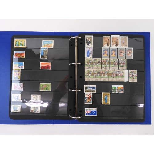 7021 - AUSTRALIA A collection of new and used stamps in three albums and a stock book to include booklets a... 