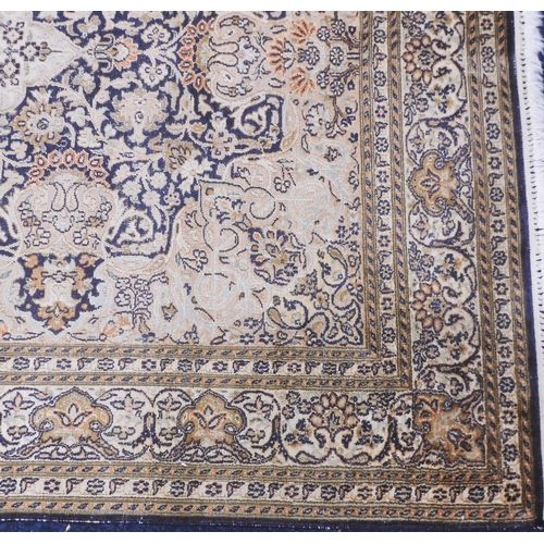 105 - A dark blue ground fine silk Kashmiri rug with cream central medallion and matching spandrels on flo... 