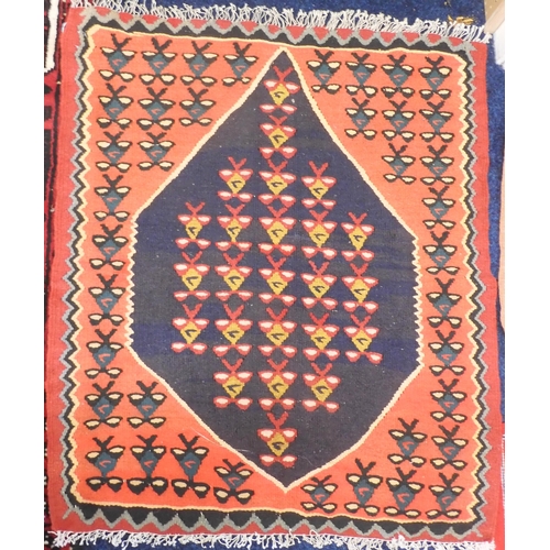 107 - A lot comprising a small red ground Kilim rug with geometric lozenge design, 108cm long x 64cm wide,... 