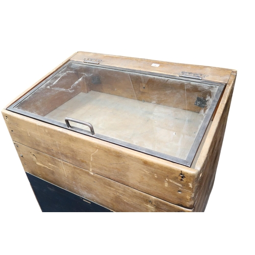 38 - A 20th century pine trolley with glazed hinged lid over large metallic drawer, 103cm high x 108cm lo... 