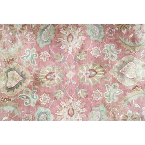 5 - A pink ground Aubusson style rug with green floral/foliate patterned ground within floral/foliate bo... 