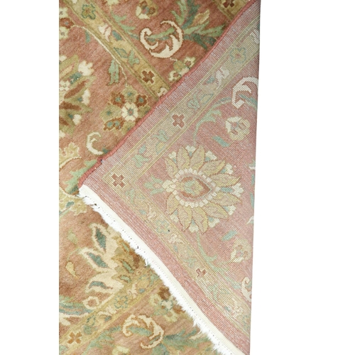 5 - A pink ground Aubusson style rug with green floral/foliate patterned ground within floral/foliate bo... 