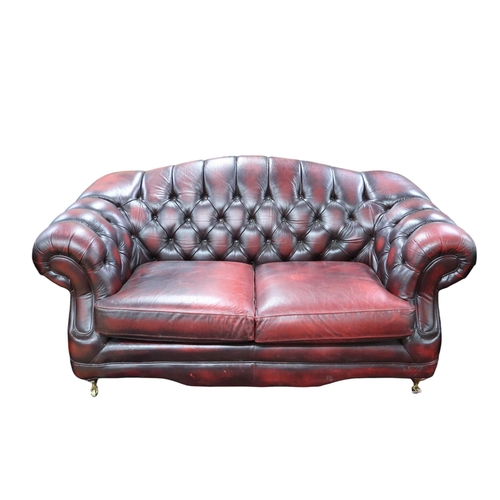 7 - A 20th century Thomas Lloyd oxblood leather upholstered three piece chesterfield style suite consist... 