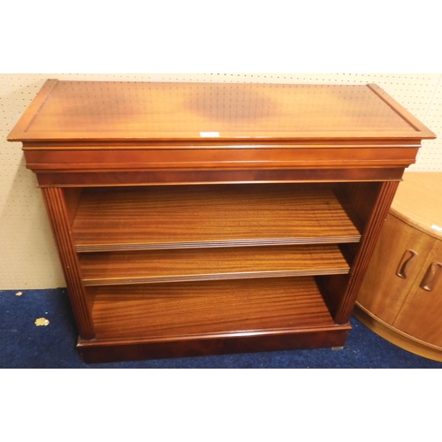 70 - A 20th century mahogany open bookcase with moulded cornice over two adjustable shelves on plinth bas... 