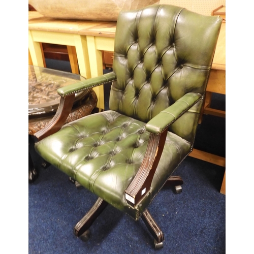 77 - A 20th century oak green leather button back upholstered swivel desk chair, 96cm high 