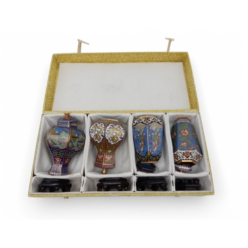 276 - A cased set of four Chinese cloisonne vases and stands