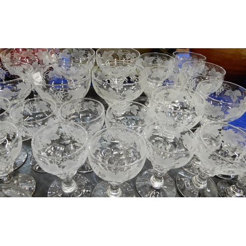 293 - A suite of vine etched glassware including drinking glasses, dessert dishes, bowl etc