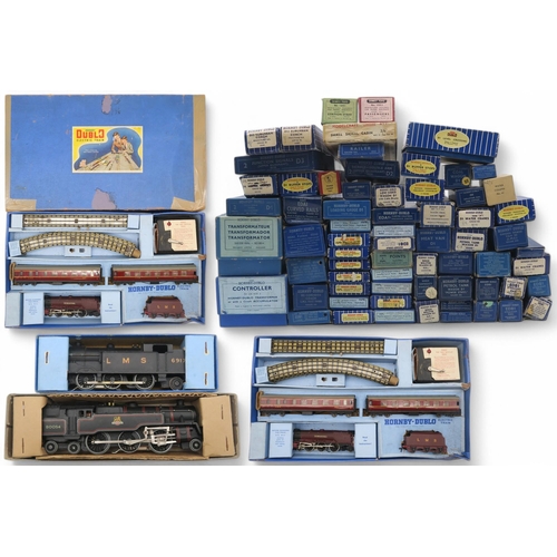 597 - A large quantity of boxed Hornby Dublo 00-gauge model railway components, including an Electric Trai... 