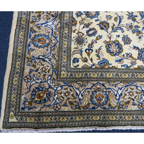 2123 - AN IVORY GROUND KESHAN FINE PILE WOOL RUG with all over floral/foliate design within multicolou... 