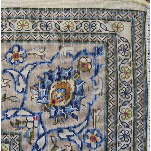 2123 - AN IVORY GROUND KESHAN FINE PILE WOOL RUG with all over floral/foliate design within multicolou... 