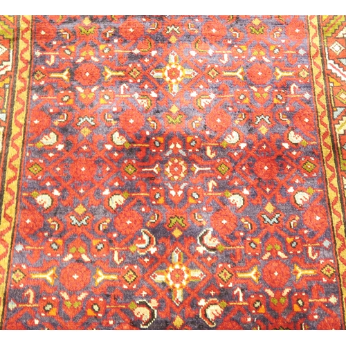 2124 - A DARK BLUE GROUND HAMADAN RUNNERwith all over geometric multicoloured design within multicolour geo... 