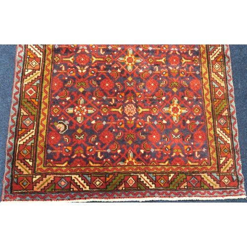 2124 - A DARK BLUE GROUND HAMADAN RUNNERwith all over geometric multicoloured design within multicolour geo... 