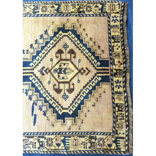 2127 - A BEIGE GROUND BALUCHI FINE PILE WOOL RUNNER with four dark geometric diamond shaped medallions... 