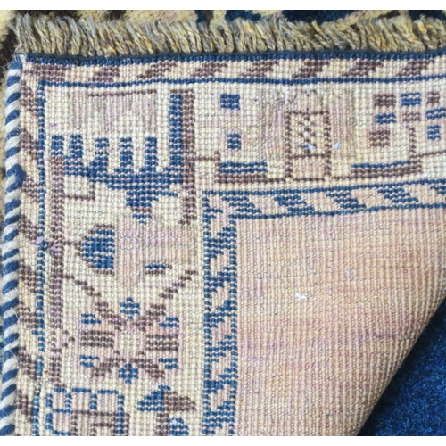 2127 - A BEIGE GROUND BALUCHI FINE PILE WOOL RUNNER with four dark geometric diamond shaped medallions... 