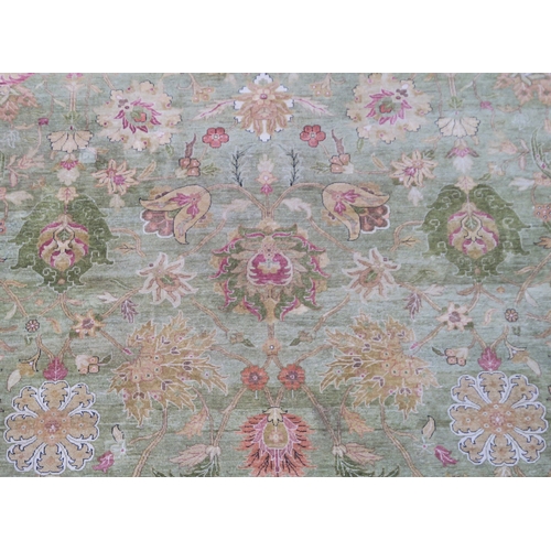 2128 - A IMPRESSIVE GREEN GROUND ZEIGLER RUGwith all over floral/foliate patterned ground within cream flor... 