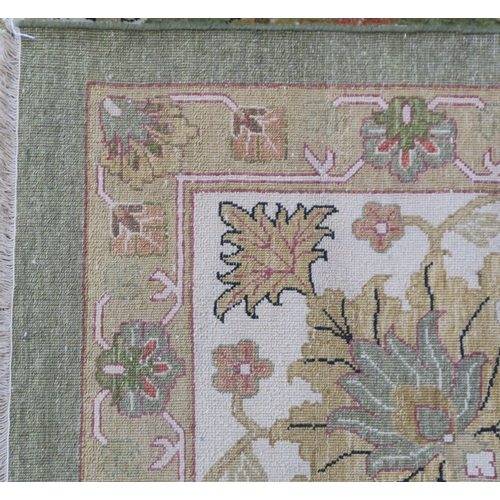 2128 - A IMPRESSIVE GREEN GROUND ZEIGLER RUGwith all over floral/foliate patterned ground within cream flor... 