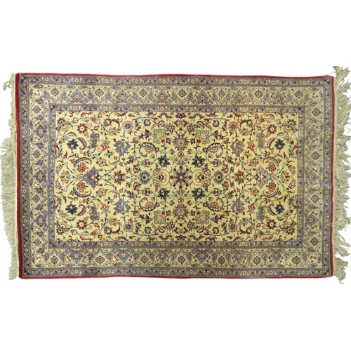 2129 - AN IVORY GROUND KESHAN FINE PILE SILK RUGwith all over floral/foliate design within red floral/folia... 