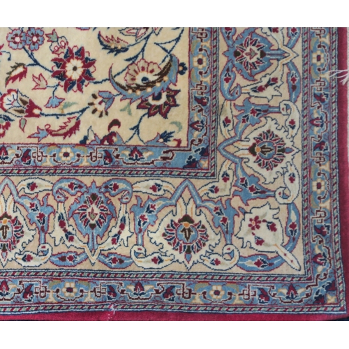 2129 - AN IVORY GROUND KESHAN FINE PILE SILK RUGwith all over floral/foliate design within red floral/folia... 