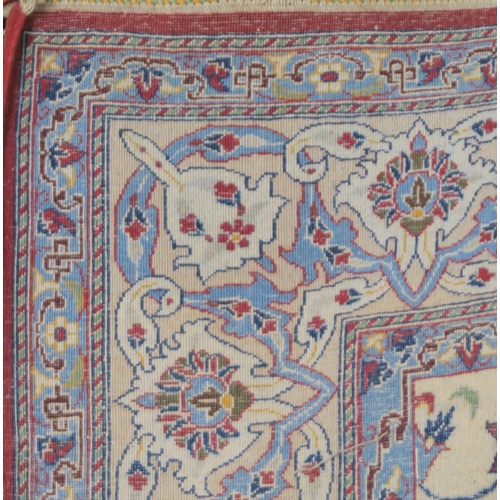 2129 - AN IVORY GROUND KESHAN FINE PILE SILK RUGwith all over floral/foliate design within red floral/folia... 