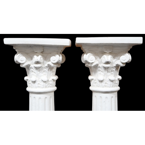 2056 - A PAIR OF EARLY 20TH CENTURY WHITE PAINTED STONEWARE PEDESTALSwith square tops on Corinthian style c... 