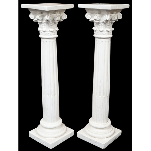 2056 - A PAIR OF EARLY 20TH CENTURY WHITE PAINTED STONEWARE PEDESTALSwith square tops on Corinthian style c... 