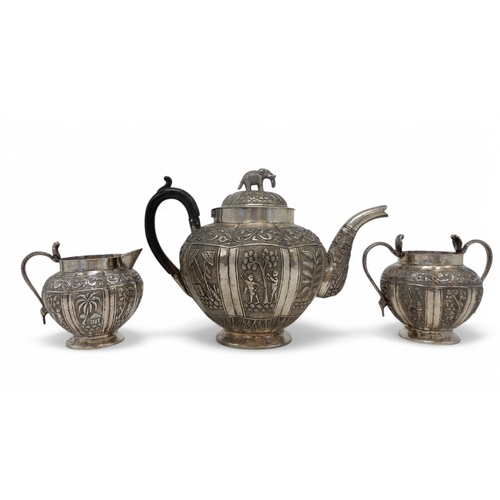 2369 - AN INDIAN THREE PIECE SILVER TEA SERVICEprobably Lucknow, of faceted form, with engraved decoration ... 