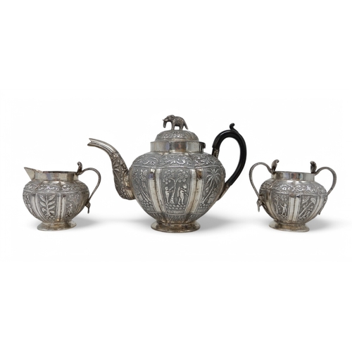 2369 - AN INDIAN THREE PIECE SILVER TEA SERVICEprobably Lucknow, of faceted form, with engraved decoration ... 