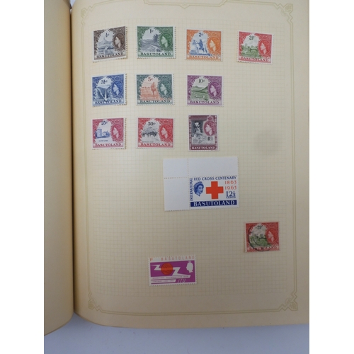 7045 - A worldwide stamp collection in four albums including 1 album of  GB with early phosphor sets, one a...