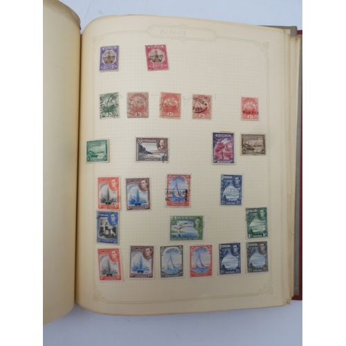 7045 - A worldwide stamp collection in four albums including 1 album of  GB with early phosphor sets, one a...