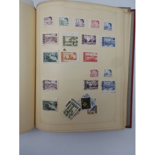 7045 - A worldwide stamp collection in four albums including 1 album of  GB with early phosphor sets, one a...