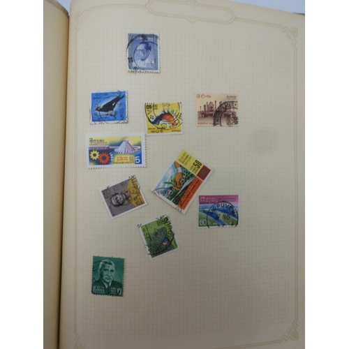 7045 - A worldwide stamp collection in four albums including 1 album of  GB with early phosphor sets, one a...