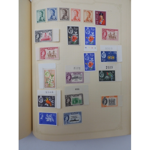 7045 - A worldwide stamp collection in four albums including 1 album of  GB with early phosphor sets, one a... 