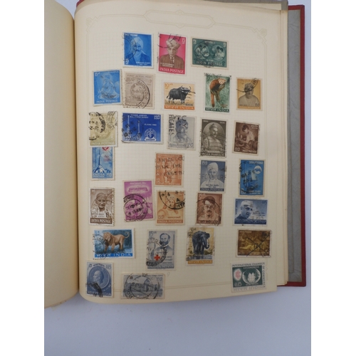 7045 - A worldwide stamp collection in four albums including 1 album of  GB with early phosphor sets, one a... 