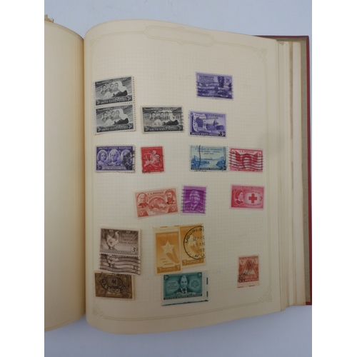 7045 - A worldwide stamp collection in four albums including 1 album of  GB with early phosphor sets, one a...