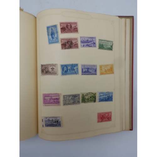 7045 - A worldwide stamp collection in four albums including 1 album of  GB with early phosphor sets, one a... 