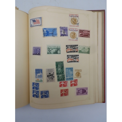 7045 - A worldwide stamp collection in four albums including 1 album of  GB with early phosphor sets, one a...