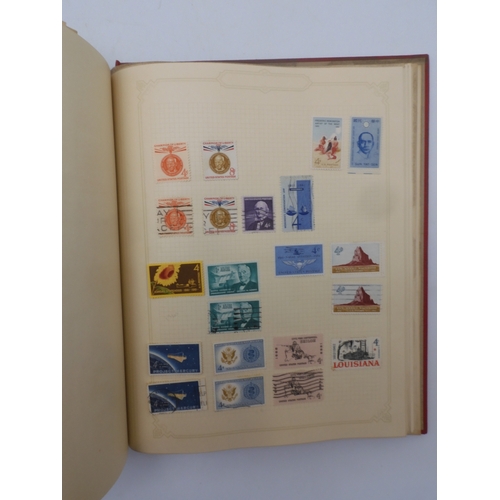 7045 - A worldwide stamp collection in four albums including 1 album of  GB with early phosphor sets, one a... 