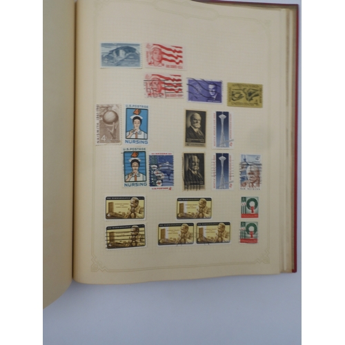 7045 - A worldwide stamp collection in four albums including 1 album of  GB with early phosphor sets, one a...