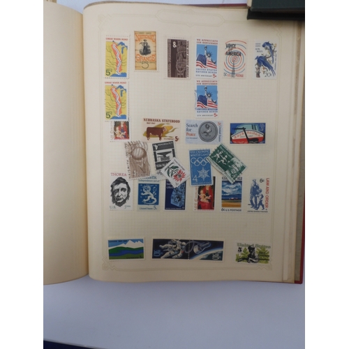 7045 - A worldwide stamp collection in four albums including 1 album of  GB with early phosphor sets, one a...