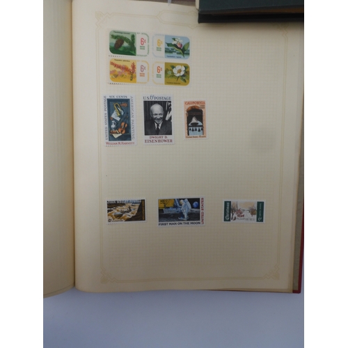 7045 - A worldwide stamp collection in four albums including 1 album of  GB with early phosphor sets, one a...