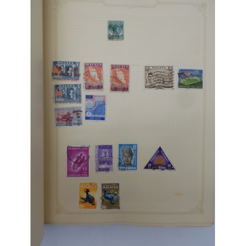 7045 - A worldwide stamp collection in four albums including 1 album of  GB with early phosphor sets, one a... 