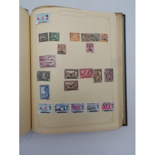 7045 - A worldwide stamp collection in four albums including 1 album of  GB with early phosphor sets, one a...