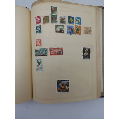 7045 - A worldwide stamp collection in four albums including 1 album of  GB with early phosphor sets, one a...