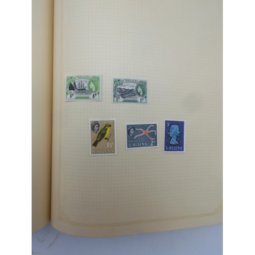 7045 - A worldwide stamp collection in four albums including 1 album of  GB with early phosphor sets, one a...