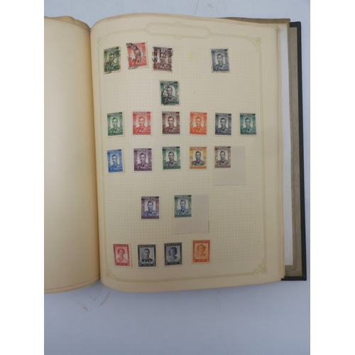 7045 - A worldwide stamp collection in four albums including 1 album of  GB with early phosphor sets, one a...