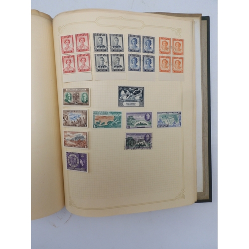 7045 - A worldwide stamp collection in four albums including 1 album of  GB with early phosphor sets, one a...