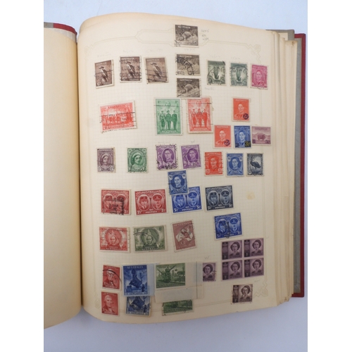 7045 - A worldwide stamp collection in four albums including 1 album of  GB with early phosphor sets, one a... 