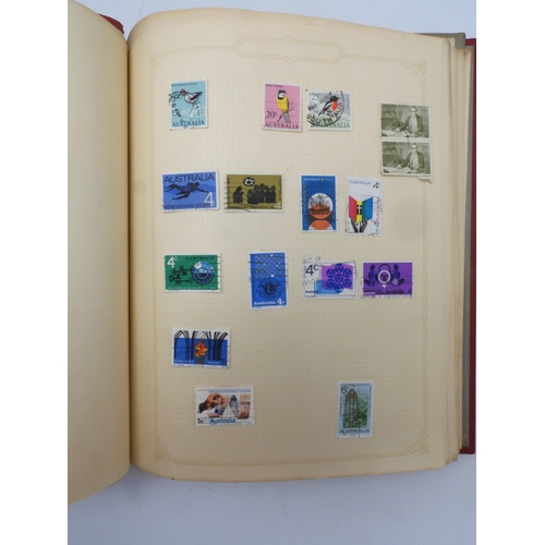 7045 - A worldwide stamp collection in four albums including 1 album of  GB with early phosphor sets, one a...