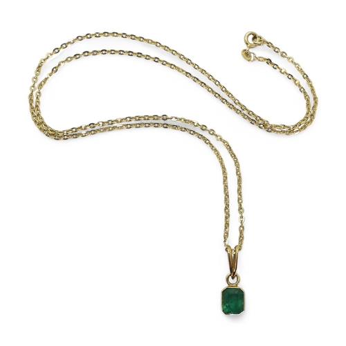 2750 - EMERALD PENDANTA bright yellow metal mounted emerald pendant. Set with a step cut emerald of estimat... 